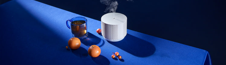 Saje diffuser placed with oranges