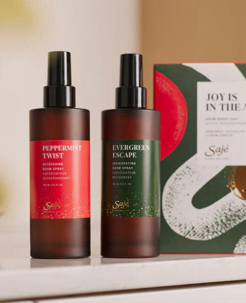 The Joy is in the Air Room Spray Duo and packaging rests on a marble countertop.