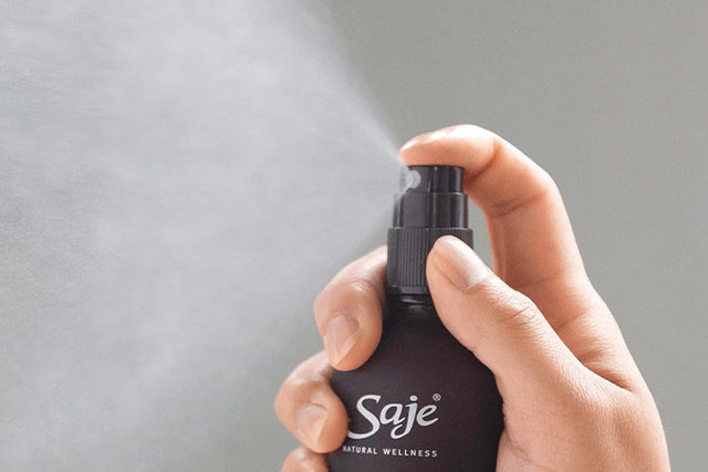 A close-up shot of someone spritzing an essential oil mist from Saje.