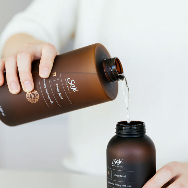 A person refilling their Tingle Mint foaming hand soap