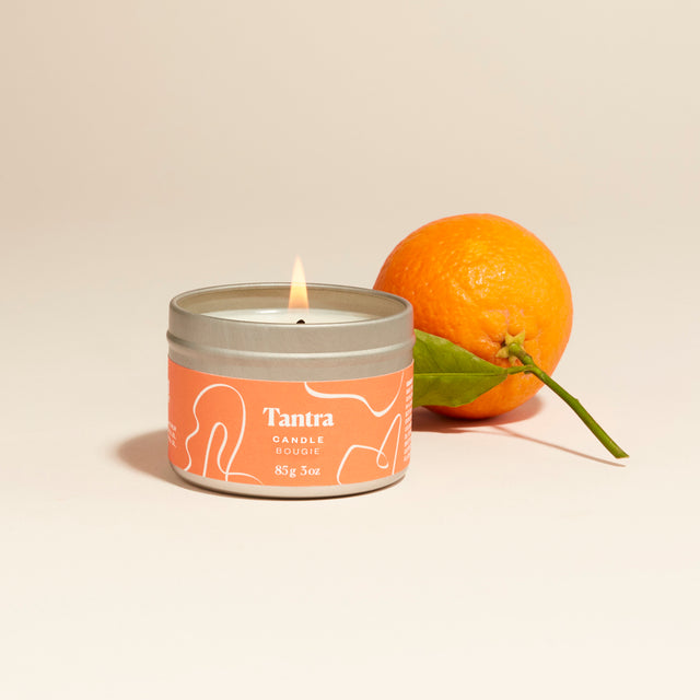 Tantra candle lit with orange beside