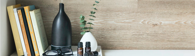 Aroma om diffuser placed with books and diffuser blends