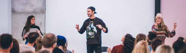 Jesse Israel speaking in front of an audience at a conference