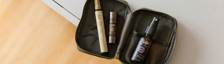 Three Saje products shown in a portable case: Peppermint Halo Wand, Peppermint Halo Roll-on and Stress Release Mist