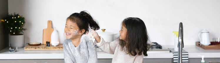 two children playing in the kitchen with Saje foaming hand soap