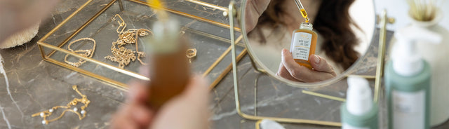 A person applying true dew face oil 