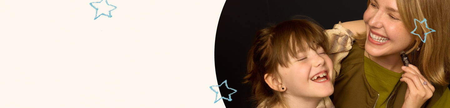 Mother and child laughing and applying peppermint halo roll on 