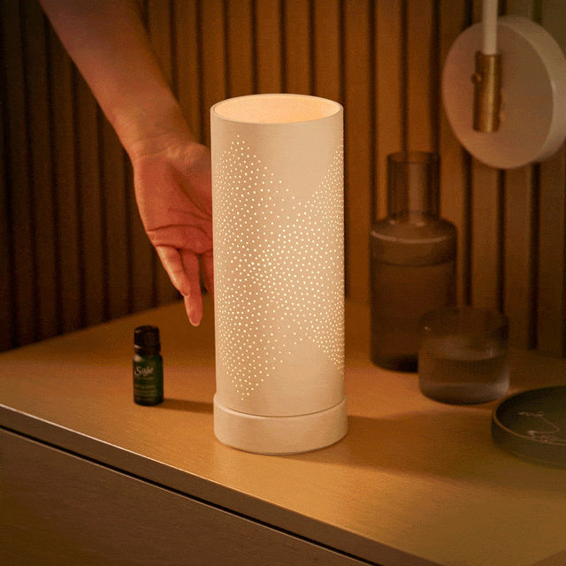 Person tapping an Aroma Light Diamond Diffuser to light it up