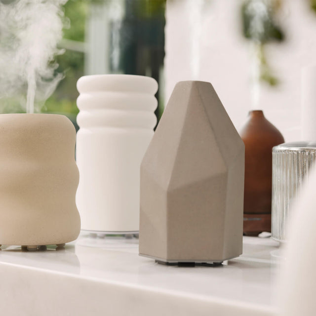 Four diffusers sitting on a counter