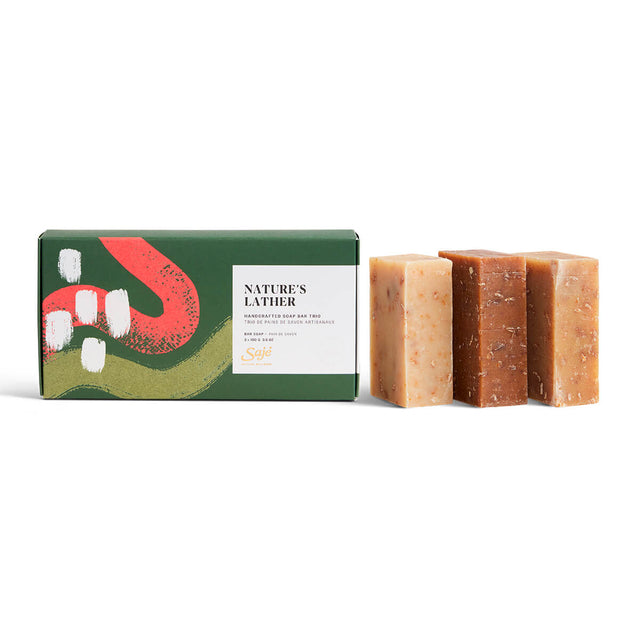 Three handcrafted bars of soap next to packaging