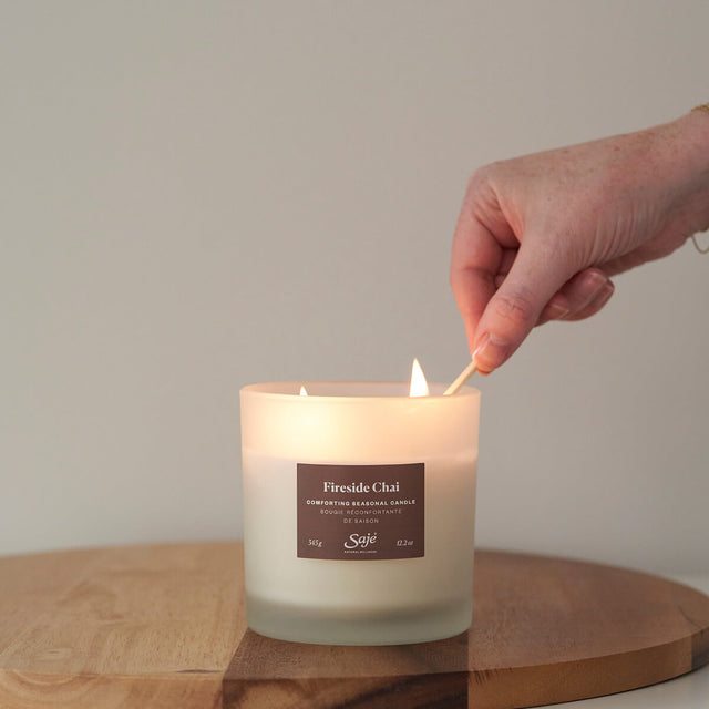 Hand lighting Fireside Chai Candle with match