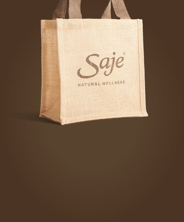 Large jute tote bag against a plain brown background.