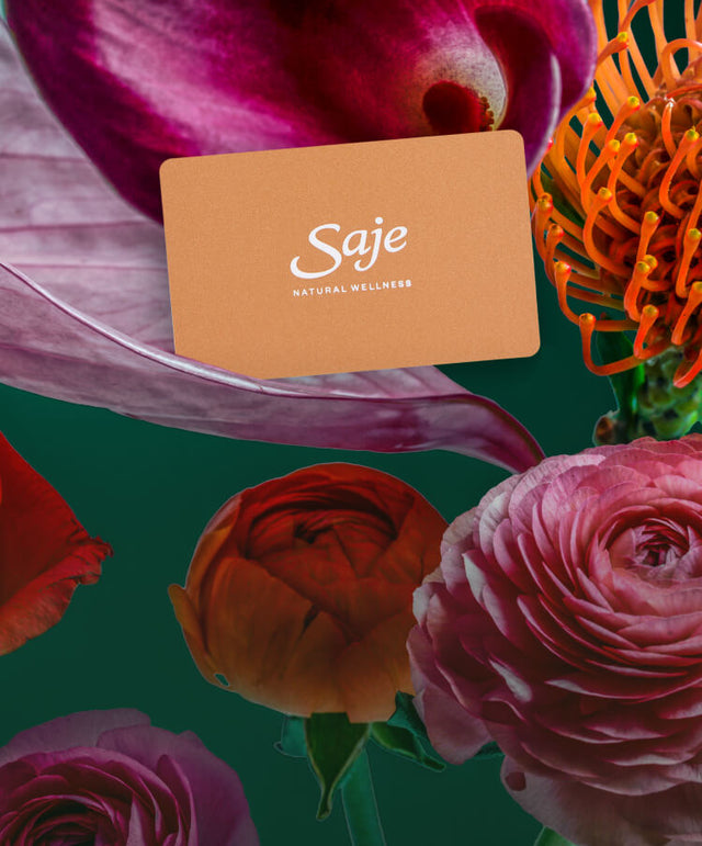 A camel-coloured gift card arranged among vibrant florals.