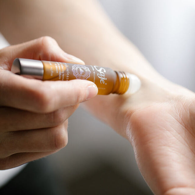 Person applying stress release roll-on to their wrist