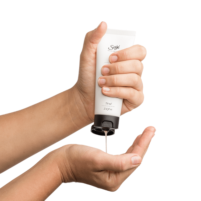 Hands holding and squeezing Tingle Mint body wash 6.6 fl oz squeeze bottle