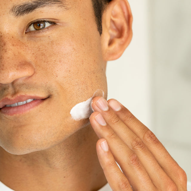 A man applying Calm-O-Mile Moisturizer into his skin 