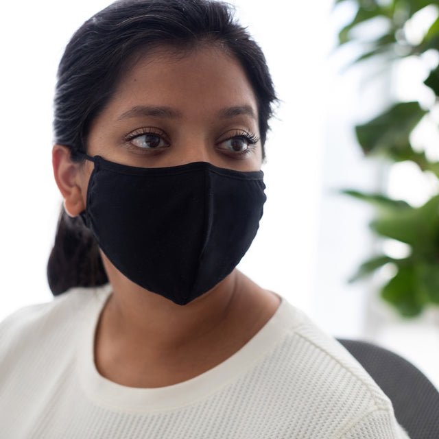Person wearing a facial mask from the top of their nose to the bottom of their chin
