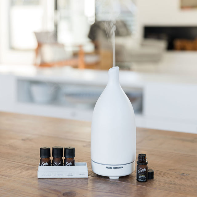 Happy Home diffuser blend collection beside Aroma Om diffuser 